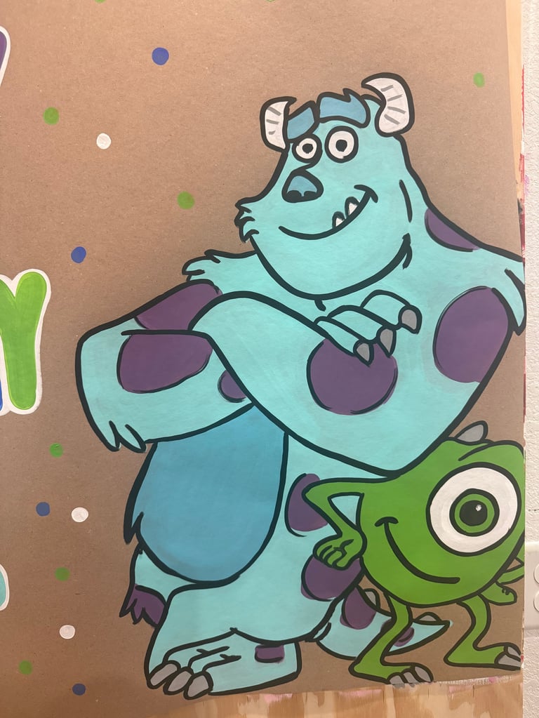 Animated blue monster with purple spots hugging a green character on a tan background with colorful dots