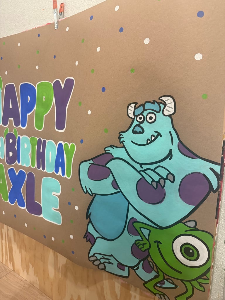 Birthday card featuring Sulley and Mike from Monsters Inc. with colorful happy birthday text and decorative dots on kraft paper