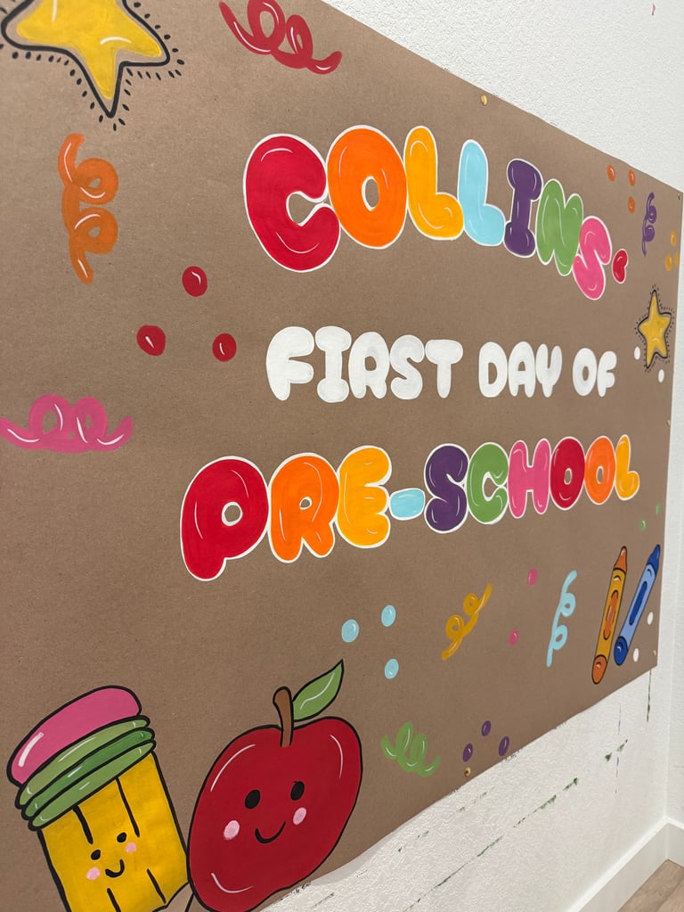 Colorful classroom bulletin board with Coloring First Day of Pre-School in rainbow letters, decorated with school supplies, apple, and star illustrations