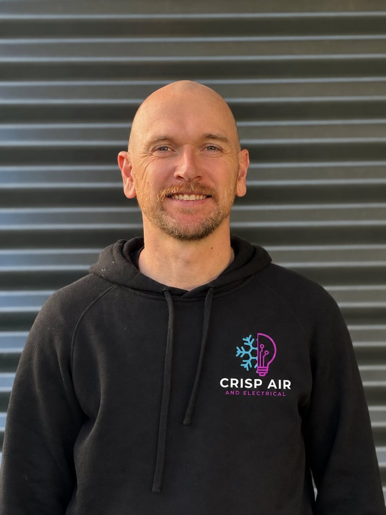Paddy, HVAC Specialist at Crisp Air and Electrical, bald with a beard in black hoodie