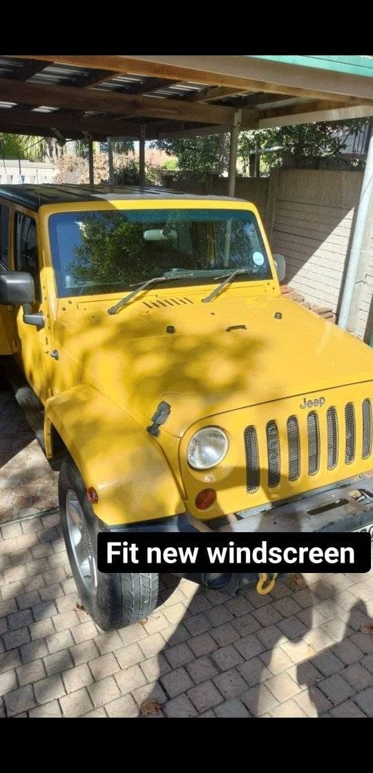 Yellow Jeep parked in carport with new windscreen fitted