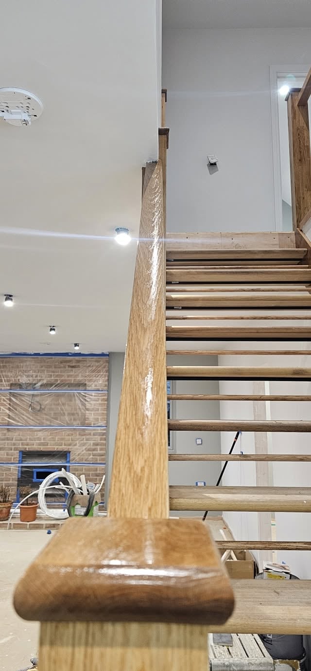 Wooden stair railing banister in residential renovation project under construction