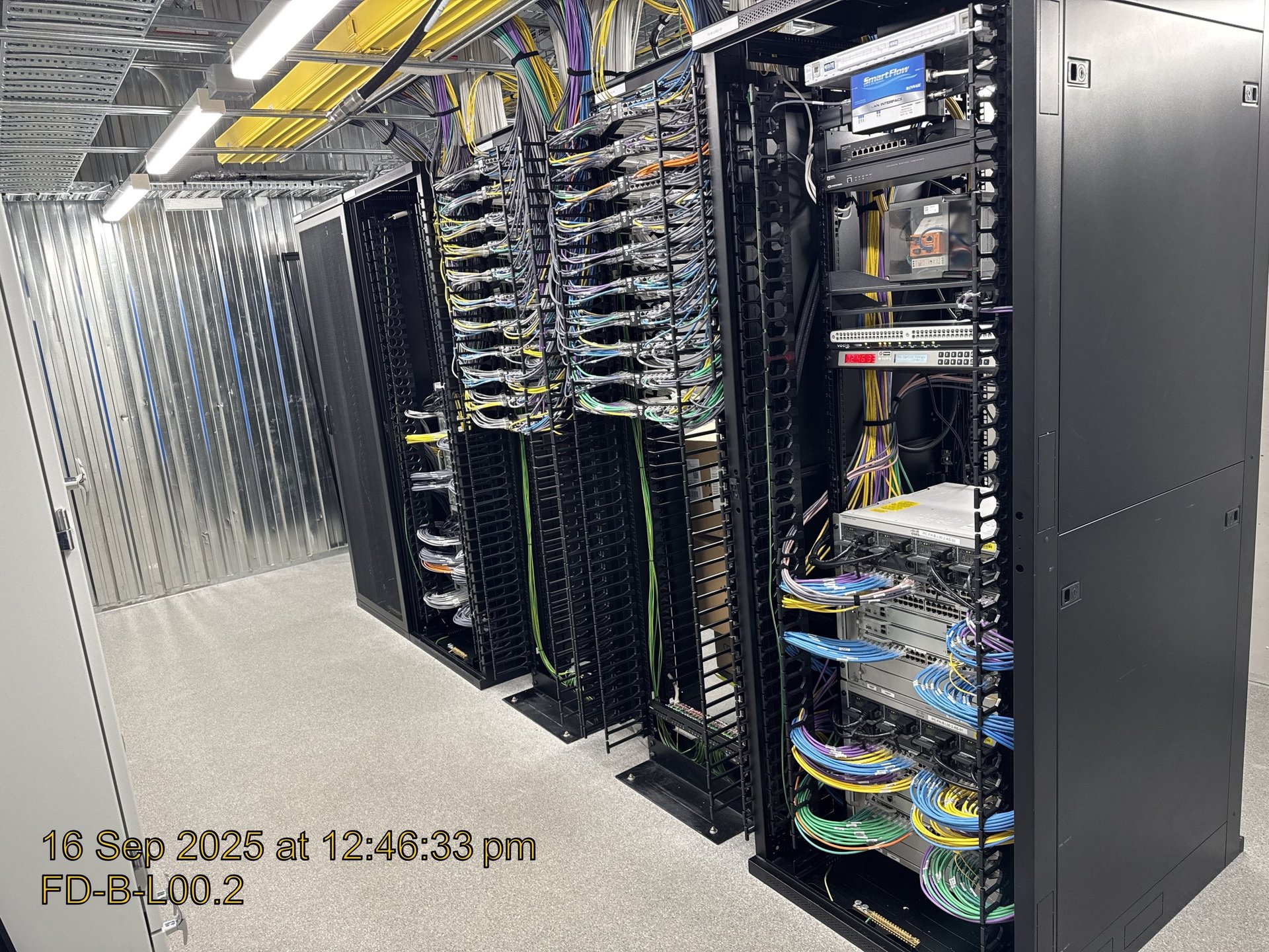 Data centre server racks with network cables and communications equipment in a Melbourne facility