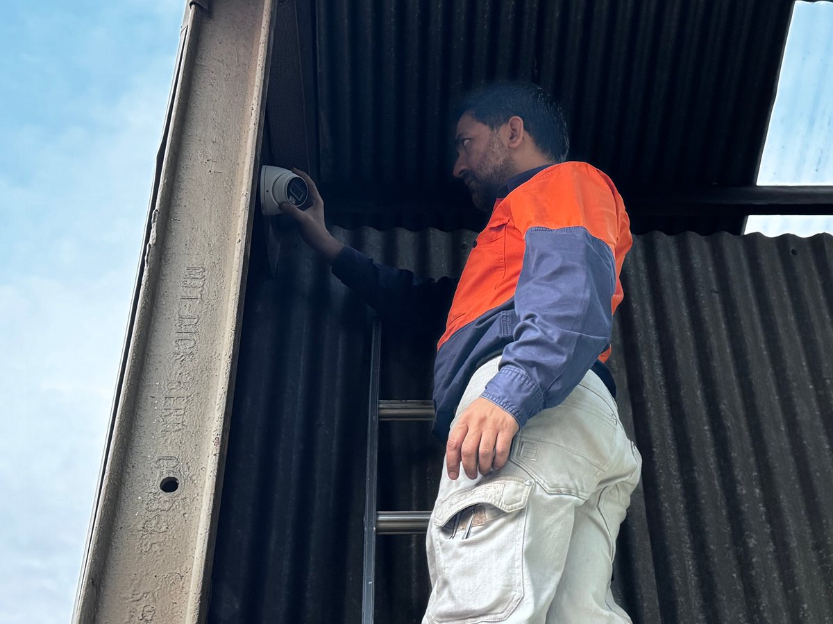 Melbourne Communication Services technician in safety gear working on an industrial communications installation, showcasing 15+ years of on-site expertise across Victoria