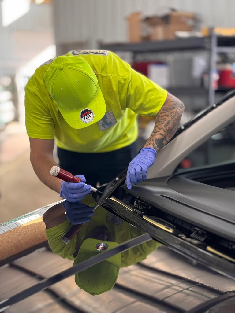 Professional auto glass technician performing windshield replacement on a vehicle at HWY 38 Glass in Tremonton Utah