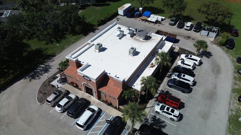 Aerial view of Tamiami Tavern restaurant and parking lot before its commercial flat roof replacement
