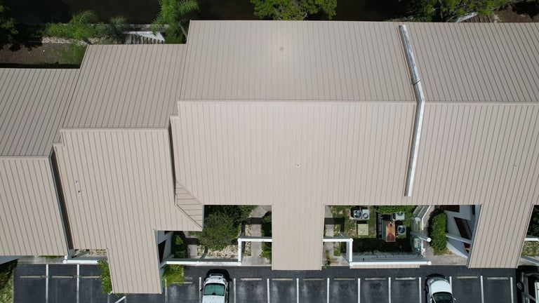 Overhead drone view of standing seam metal roof panels on a commercial building in Cape Coral, FL