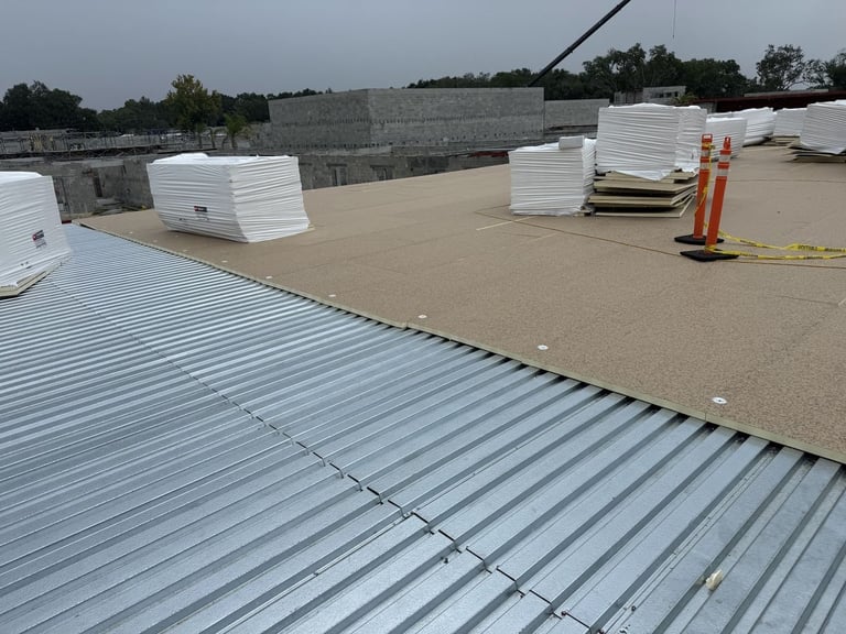 Polyiso roof insulation mechanically fastened over a corrugated steel deck on a commercial flat roof in Leesburg, FL