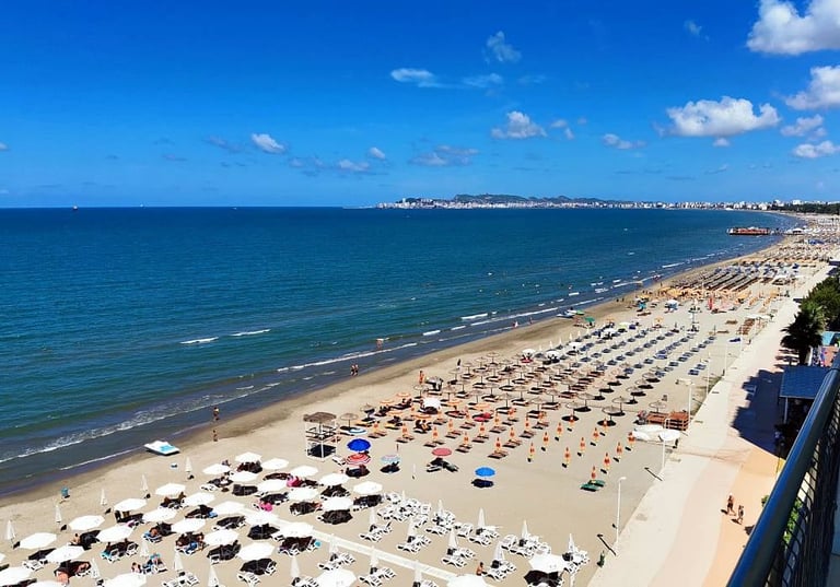 Pogled na plažu Drač iz ptičje perspektive sa redovima suncobrana i tirkiznom vodom