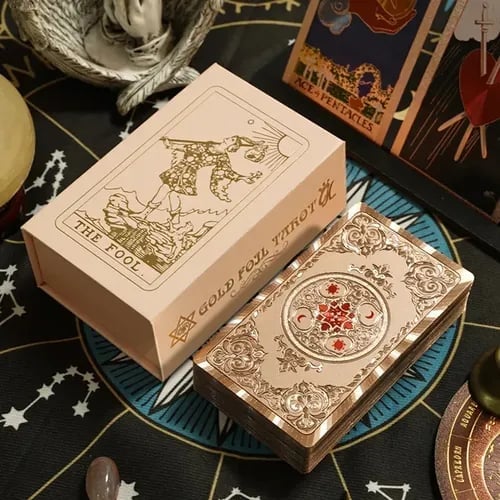 Tarot card boxes displayed on an astrological cloth with mystical items and celestial-themed decorations