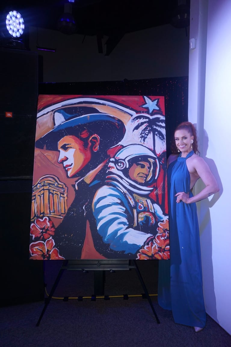 Woman in blue dress posing next to vibrant pop art painting featuring a cowboy and astronaut on a red background