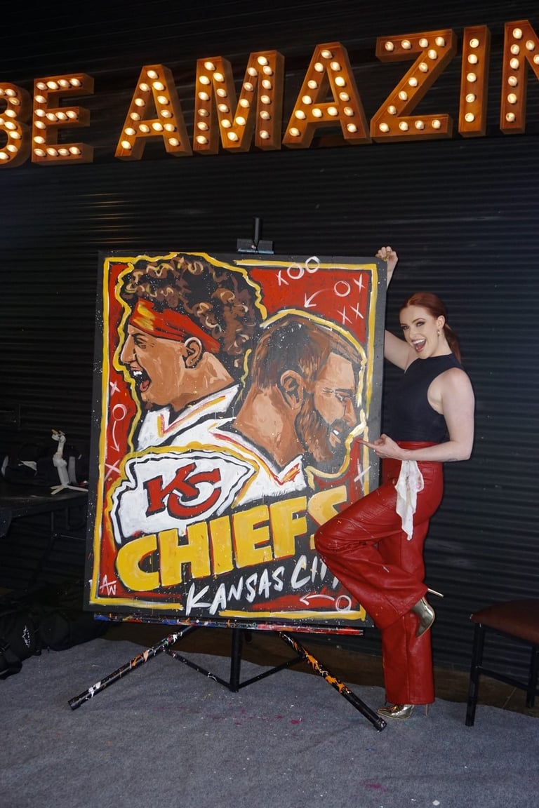 Woman in red pants posing next to Kansas City Chiefs artwork under glowing marquee sign