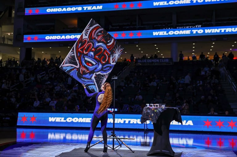 Performer on stage at Chicago basketball arena with large neon logo projection and Welcome signage in background