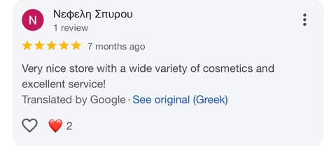 Five-star Google review from Nefeli Spyrou praising a cosmetics store for variety and service quality