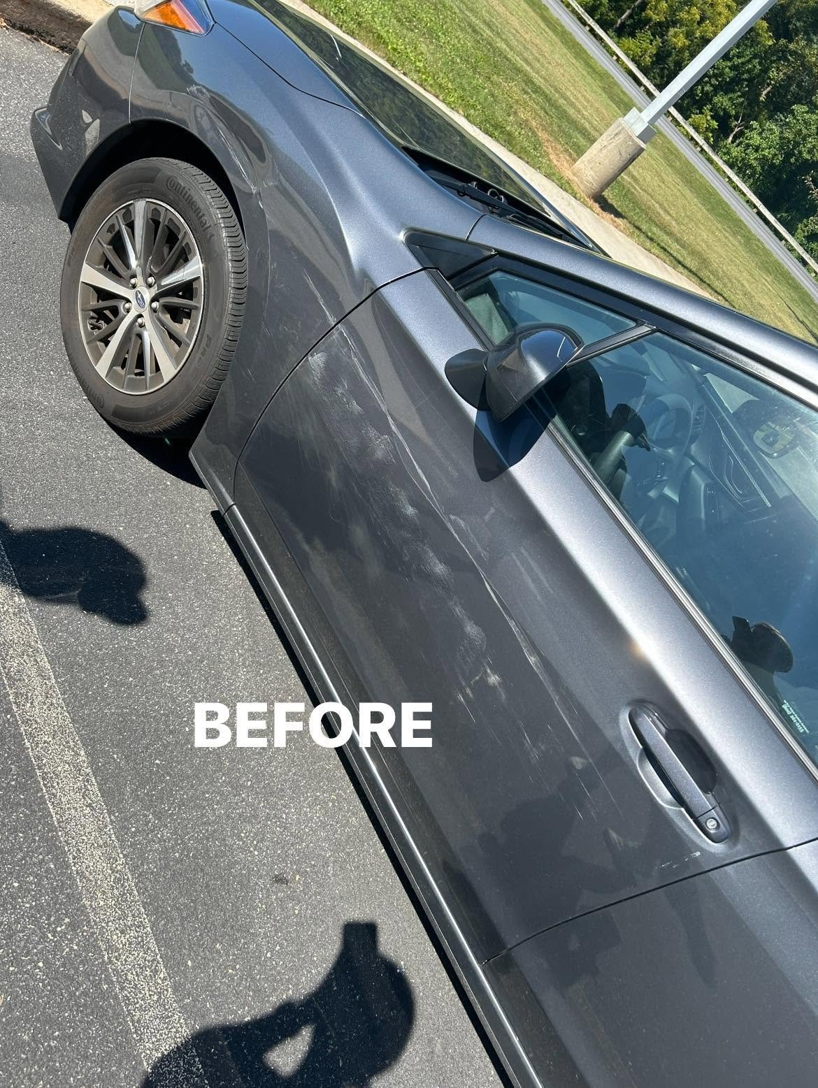 Gray sedan with a dented front fender shown from above before paint correction work