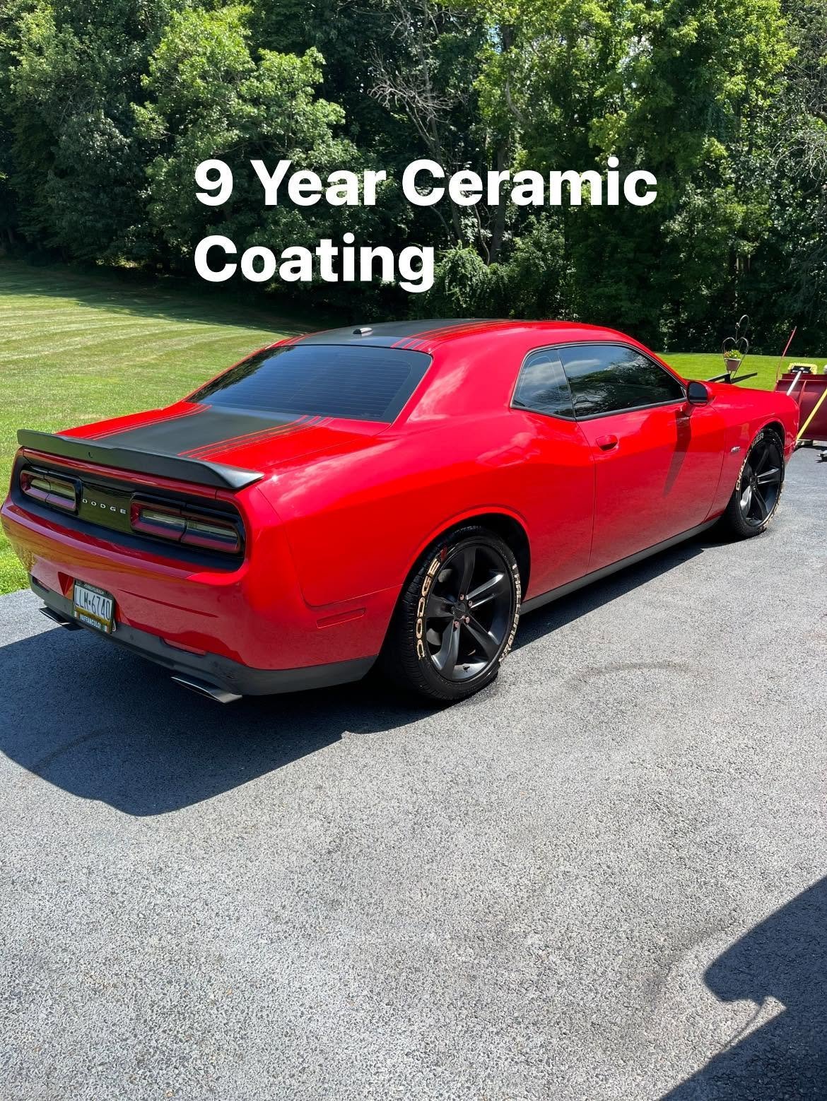 Bright red Dodge Challenger muscle car with a black hood stripe and a deep gloss finish after ceramic coating