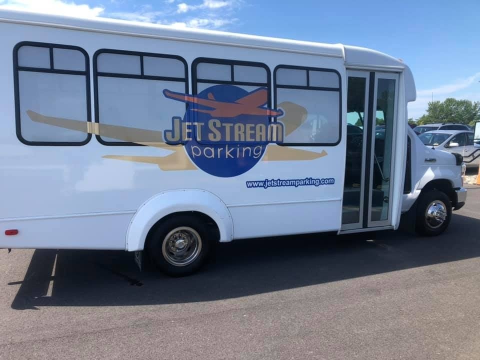 White Jet Stream Parking shuttle bus with blue logo on the side, detailed and parked in a lot