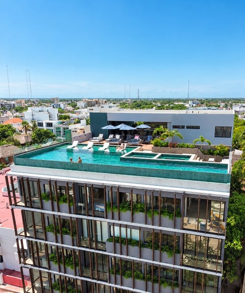 Rooftop pool and lounge area on modern building with urban cityscape in background