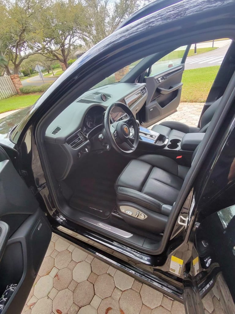 Black Porsche sports car interior with leather seats