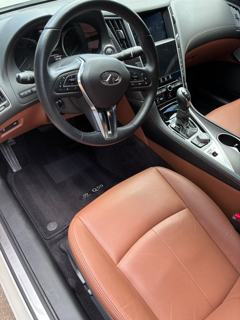 Luxury car interior with leather steering wheel and clean dashboard