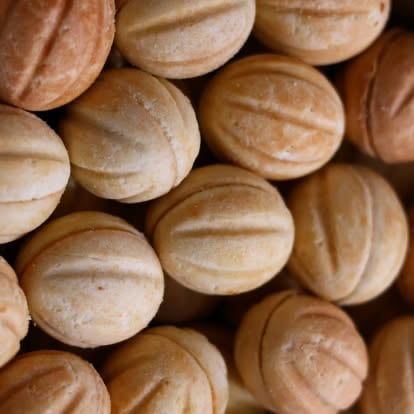Overhead view of round whoopie pies or sandwich cookies with ridged tops and tan-brown color