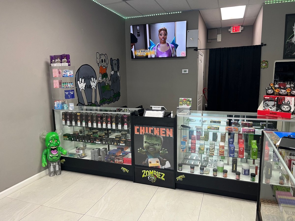 Retail display counter with collectible figures, gaming merchandise, and merchandise cases in a specialty store interior