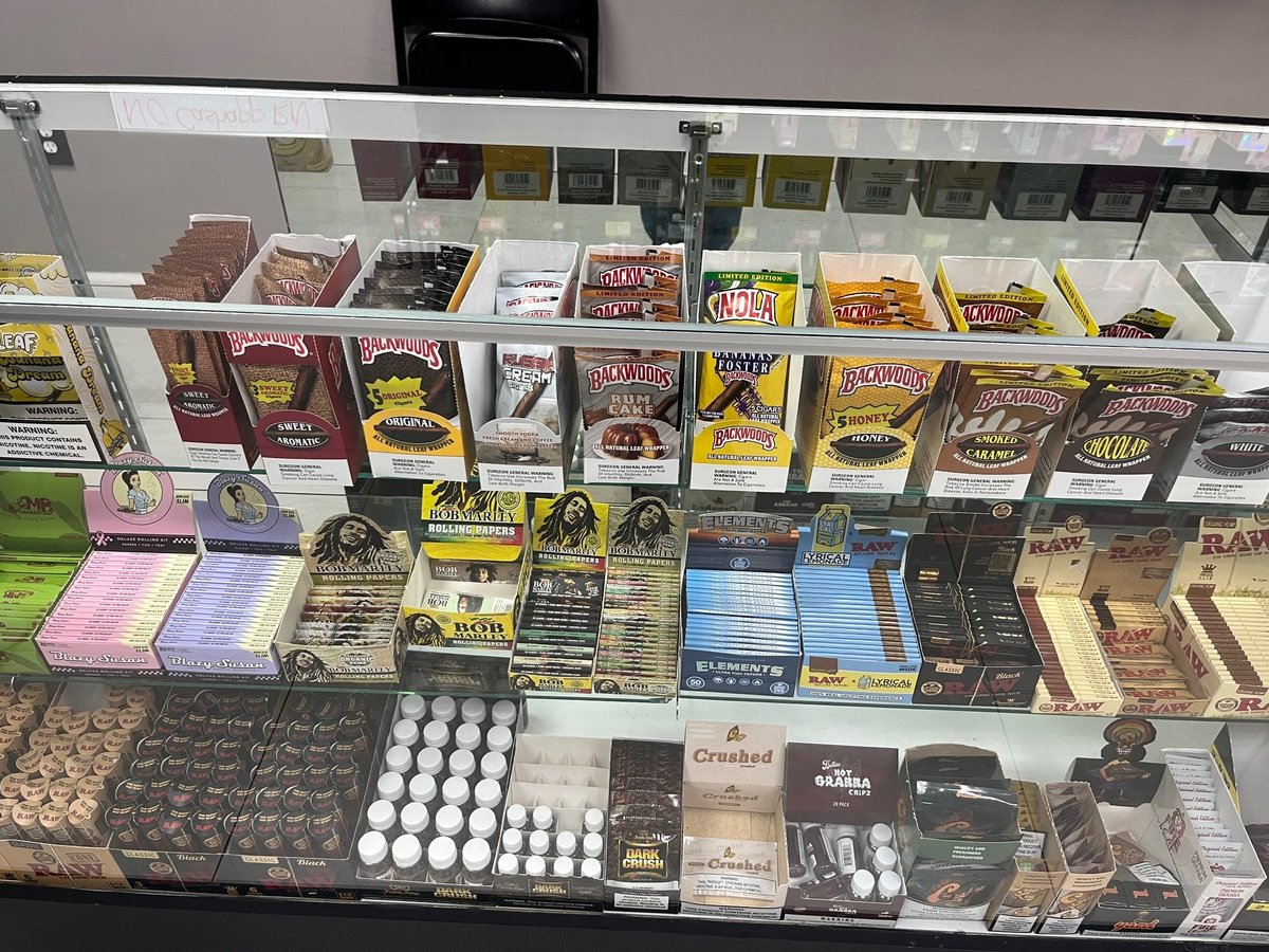 Display case filled with various chocolate bars, candies, and confectionery products arranged on multiple shelves