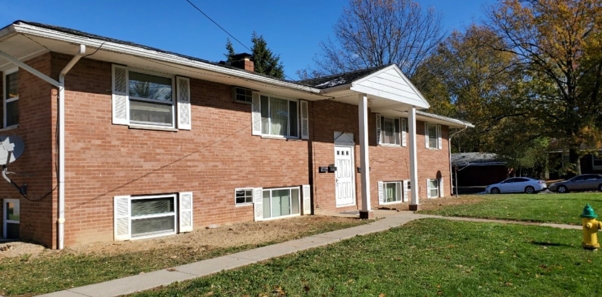 Two-story brick house with white trim and front porch