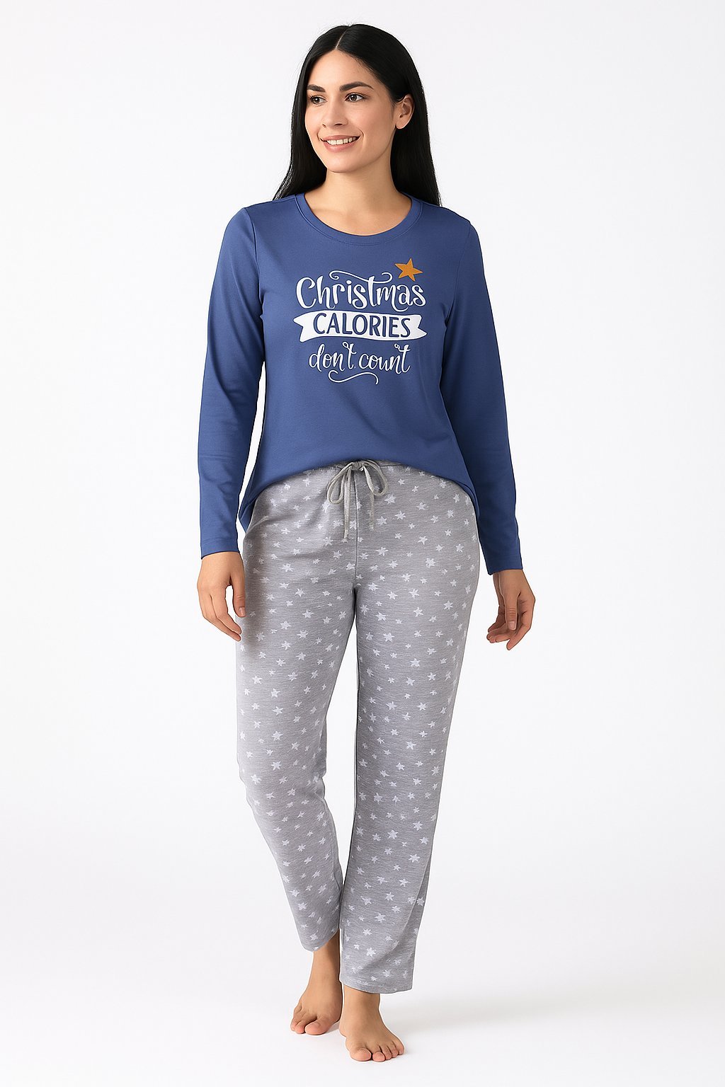 Woman wearing blue long-sleeve pajama top with Christmas calories text and gray polka dot pajama pants