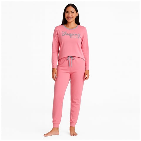 Woman wearing pink long-sleeve Sleepwear pajama set with matching sweatpants
