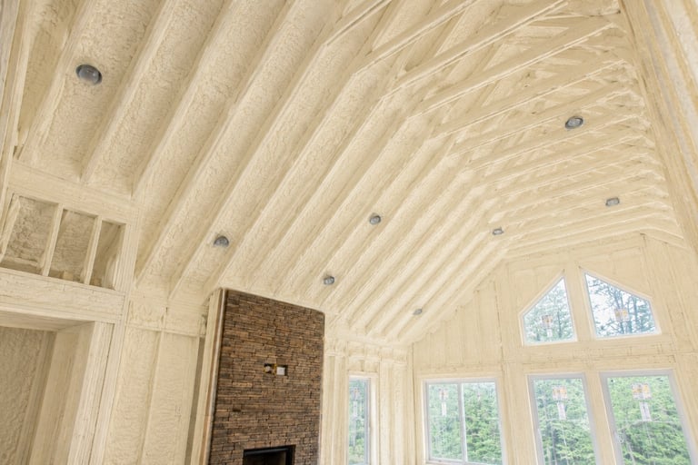 Modern sunroom interior with vaulted wood ceiling, recessed lighting, brick fireplace, and large arched windows overlooking greenery
