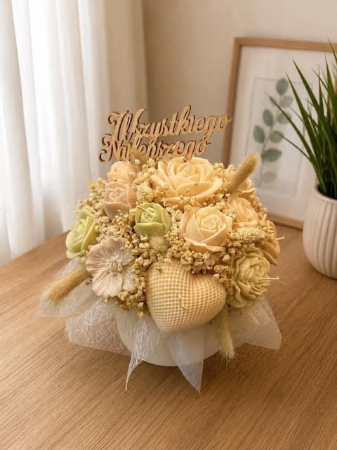 Decorative dried flower arrangement in beige ceramic vase with wooden anniversary topper on wooden table