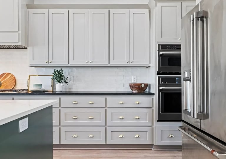 Classic white kitchen with subway tile backsplash and dark countertops — Southern Shore cabinetry