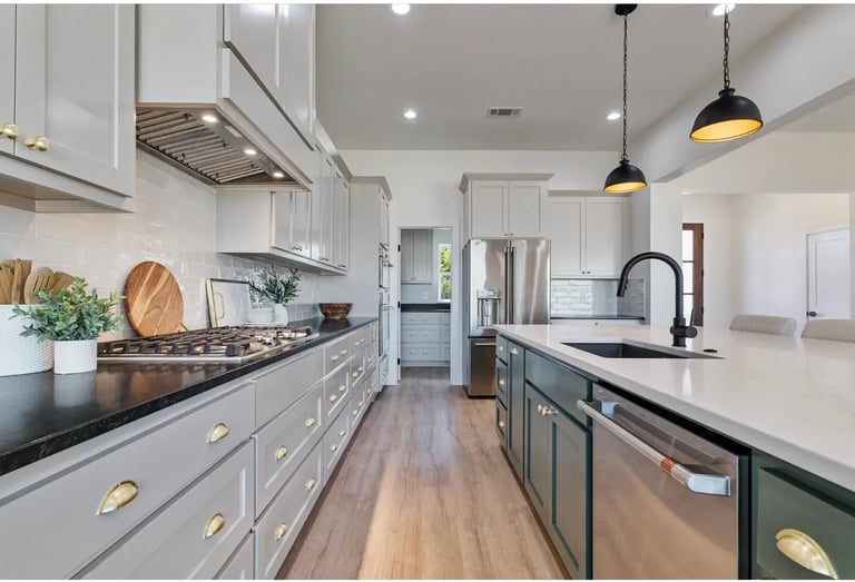 Two-tone kitchen with white and gray cabinetry, black pendant lights — Southern Shore custom design