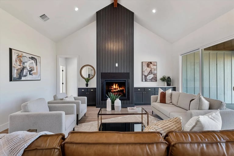 Modern living room with fireplace, beige seating, leather sofa, and contemporary decor