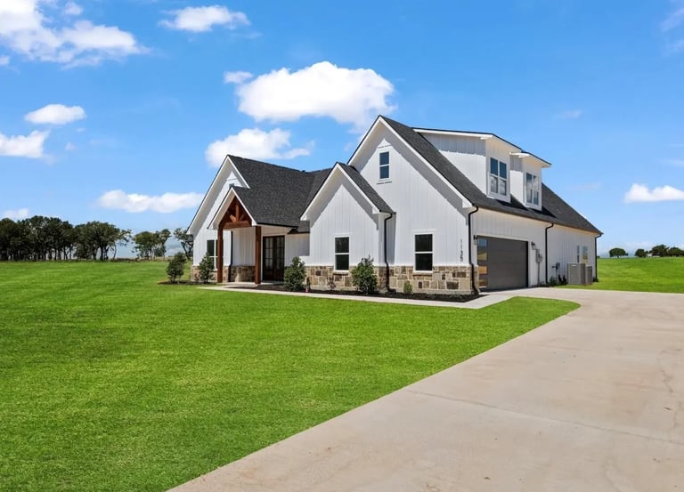 Modern farmhouse on expansive green lawn — Southern Shore exterior