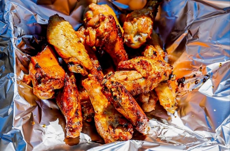 Golden-brown seasoned potato wedges served in a foil wrapper