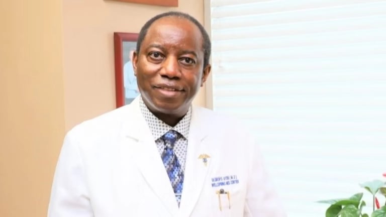 Dr. Oluropo Ayeni — Medical Director at Wellspring Medical Center, wearing white lab coat