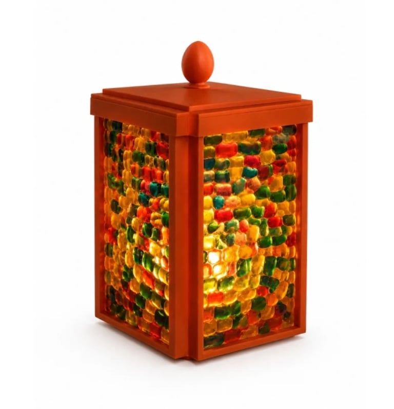 Red decorative lantern with multicolored mosaic glass panels and ornamental finial top