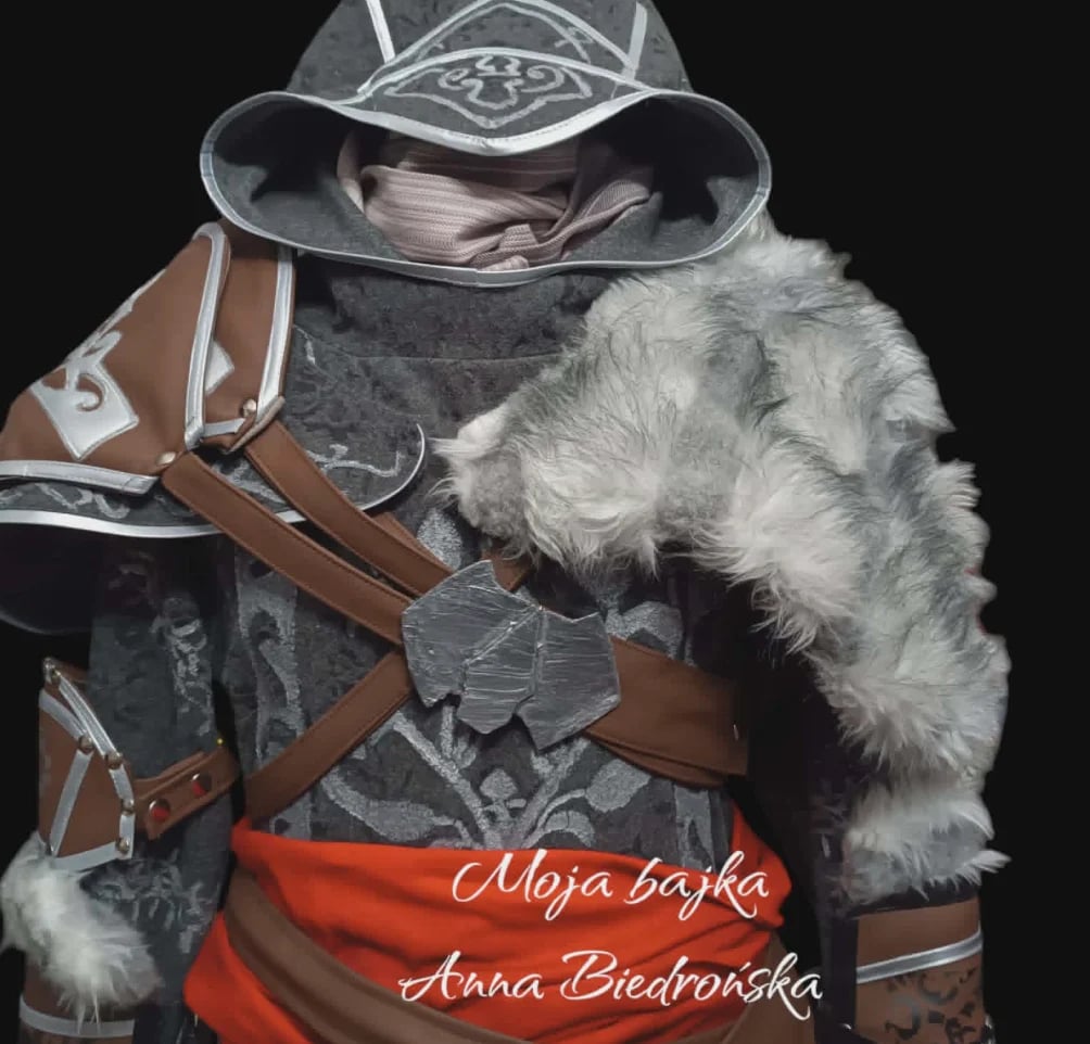 Small white dog dressed in medieval warrior outfit with hat, armor, and brown straps, against black background