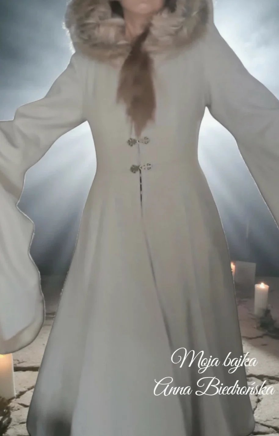Woman in cream-colored long coat with fur collar and fastened buttons, standing against misty background with candles