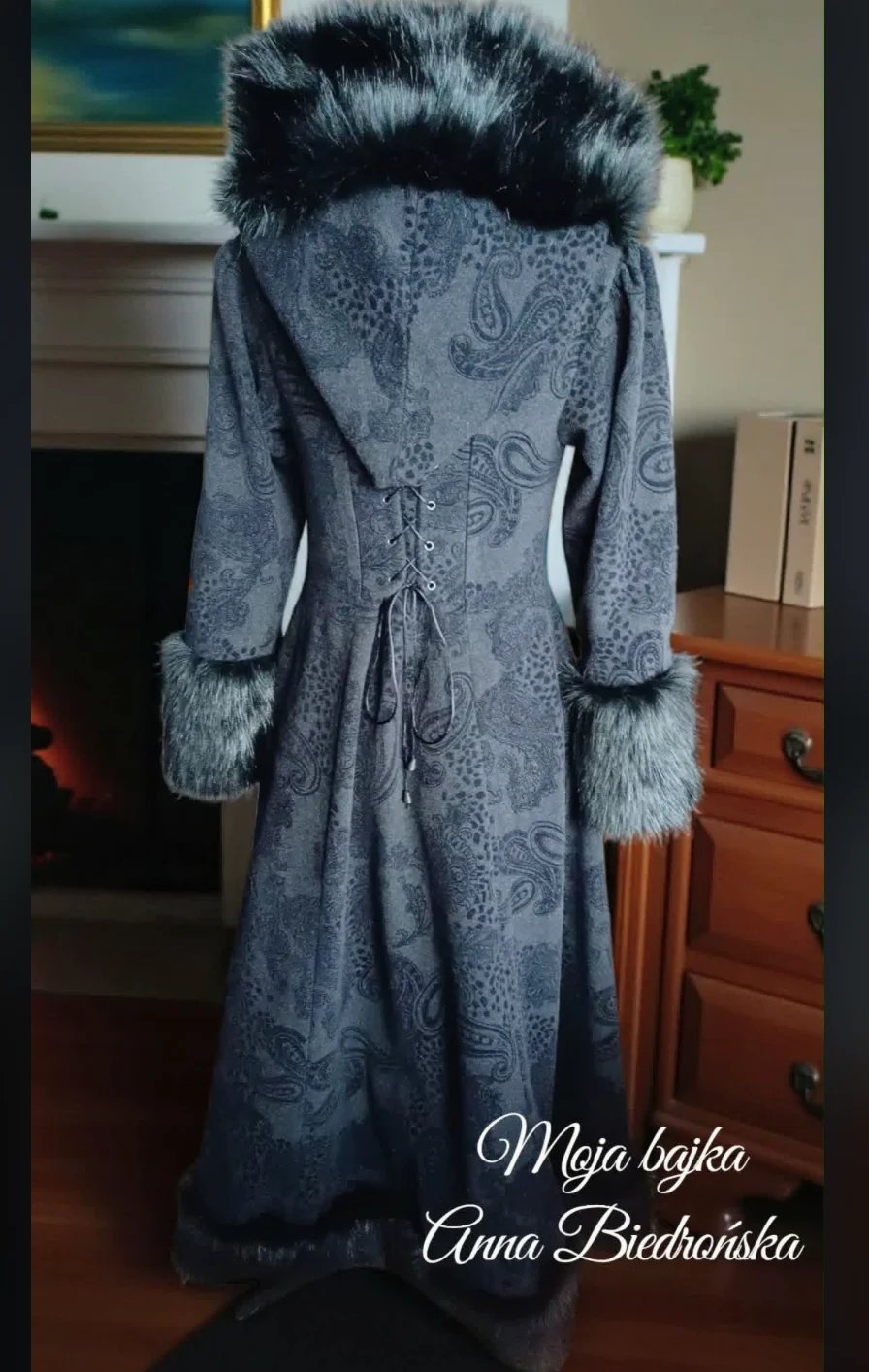 Gray paisley print coat with black fur-trimmed hood and cuffs displayed on a dress form indoors.