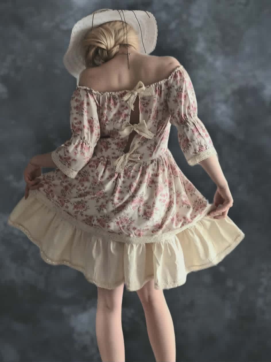 Woman wearing a vintage-style floral dress with puffed sleeves and cream-colored petticoat, viewed from behind