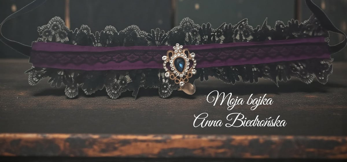 Ornate hearse with purple draping and decorative diamond brooch, with elegant script text below