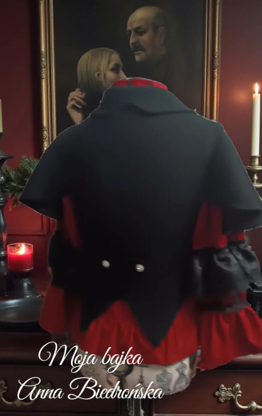 Person in black and red cape viewed from behind, looking at portrait of blonde woman and bearded man in ornate gold frame