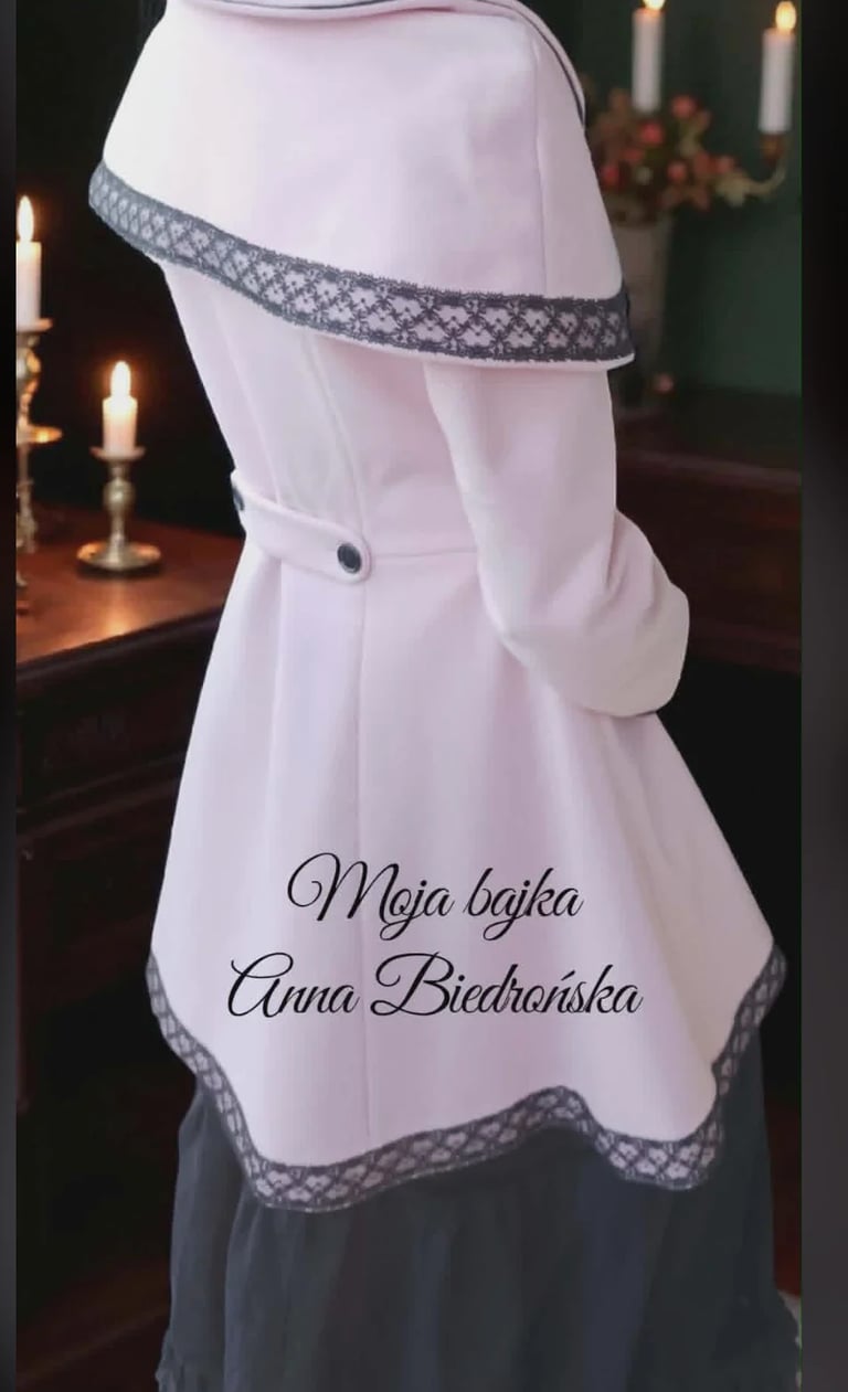 White apron with gray lace trim displayed on a dress form, with candlelit interior background and text overlay