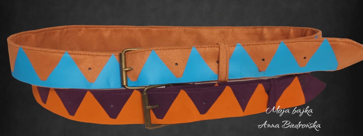 Two decorative belts with geometric triangle patterns in blue and orange on tan and purple leather against a black background