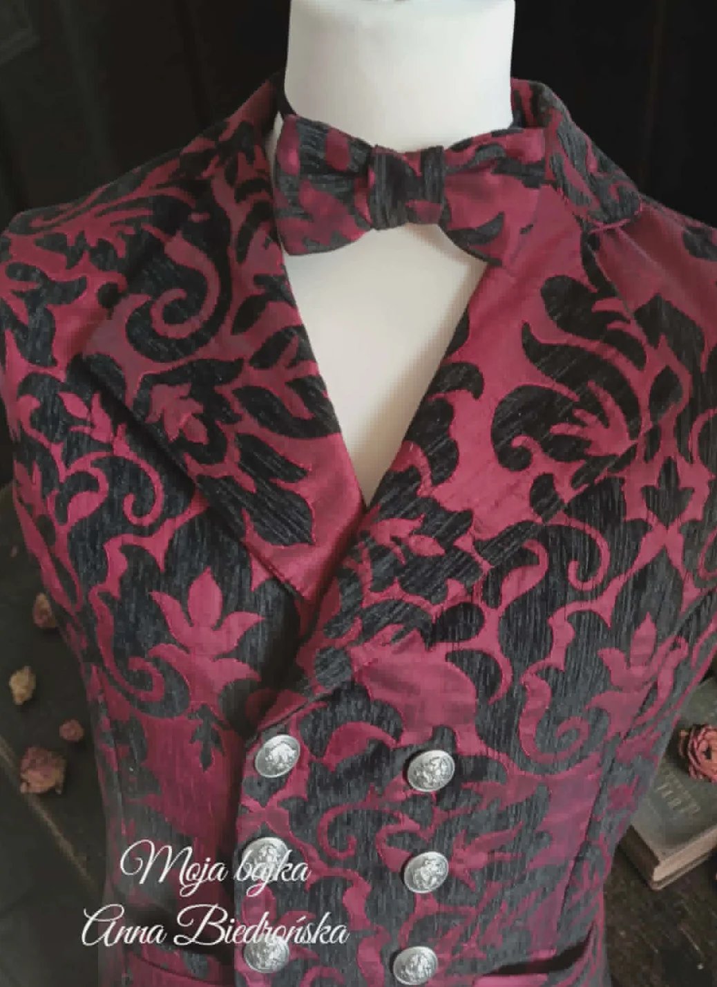 Burgundy velvet blazer with black damask pattern, double-breasted buttons, and matching bow tie on mannequin