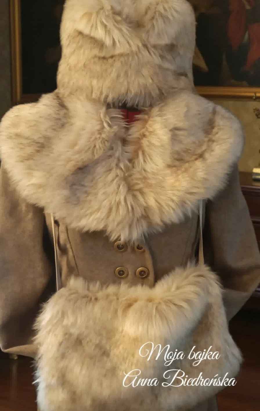 Beige coat with fur collar and cuffs displayed on a dress form, featuring double buttons and cream-colored fur trim