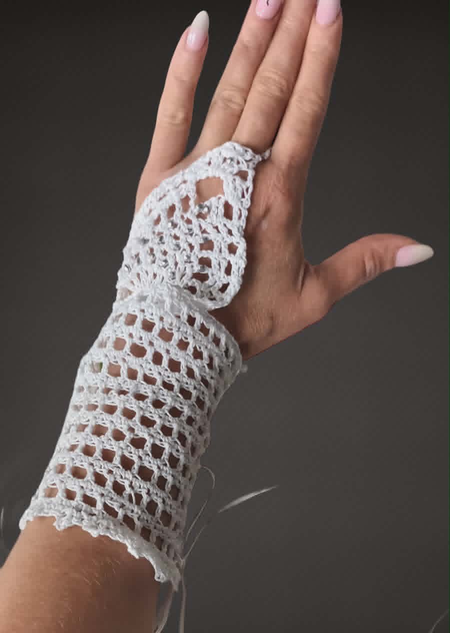 Hand wearing a white lace fingerless glove against a gray background